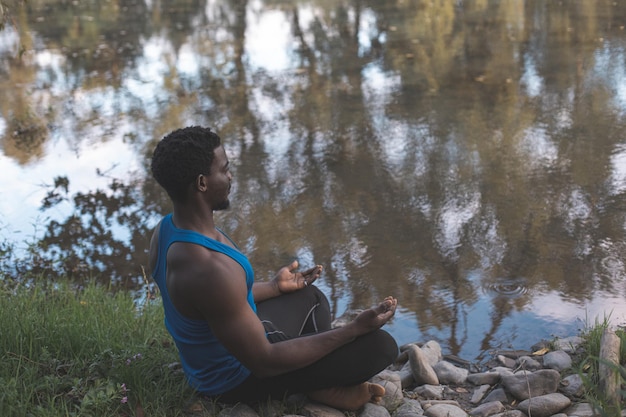 The young man have a meditation by the river