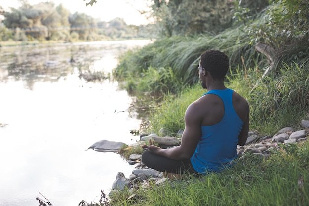 The young man have a meditation by the river