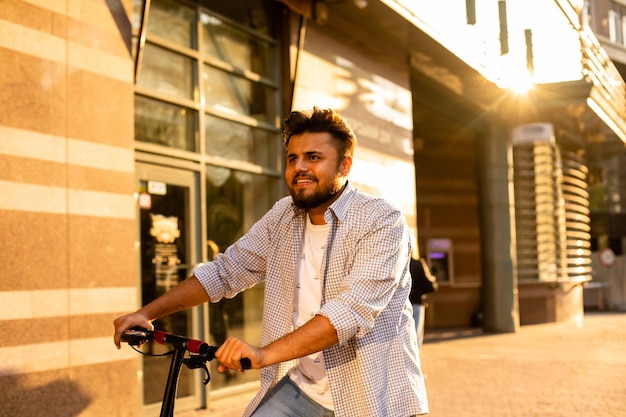 The young man have nice mood while rides an electric scooter