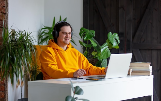 Young man in headphone working at home office