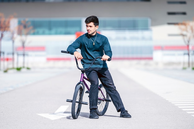 Young man next to his bicycle