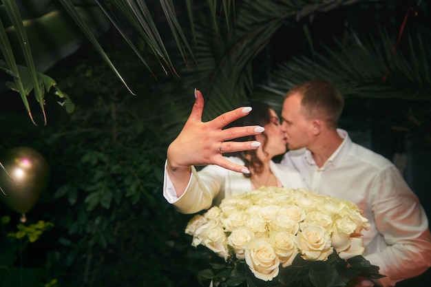 Young man and his happy fiancee showing engagement ring Valentine day