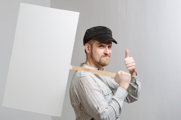 Young man holding a blank banner