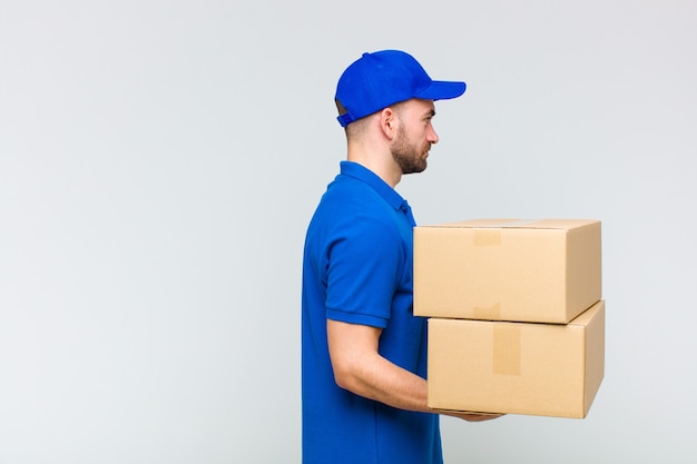 Young man holding boxes