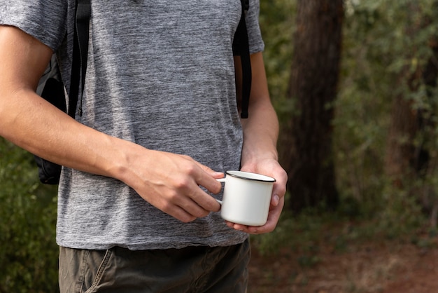 Young man holding cup