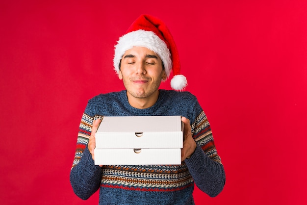 Young man holding a gift on christmas day