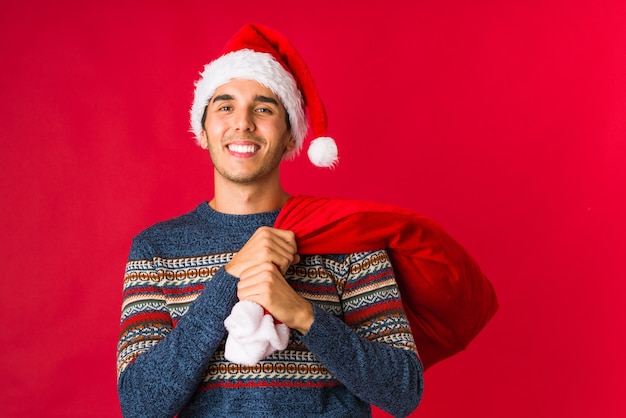 Young man holding a gift on christmas day