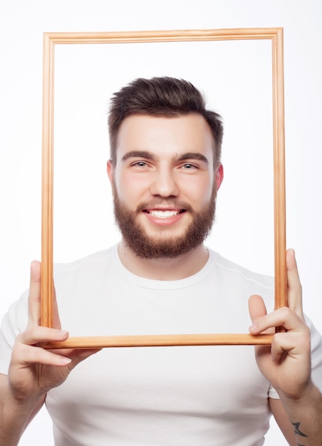 Young man holding picture frame