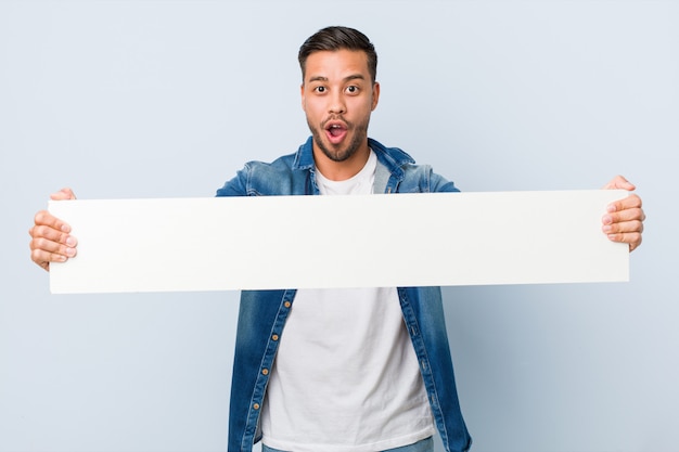 Young man holding a white placard.