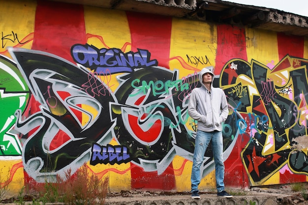 A young man in a hoodie hip-hop in the tunnel