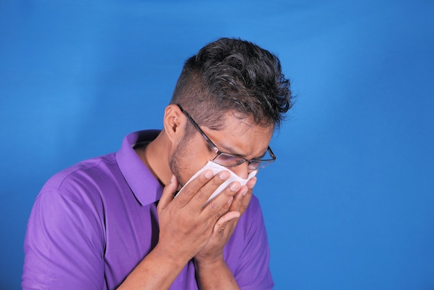 Young man i casual dress suffering sneezes and coughs