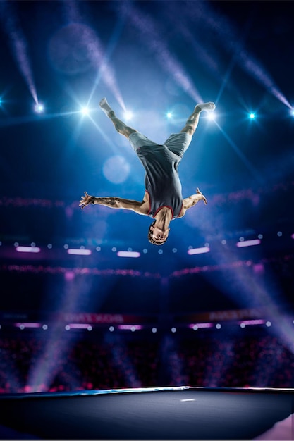 Young man is jumping on the trampoline