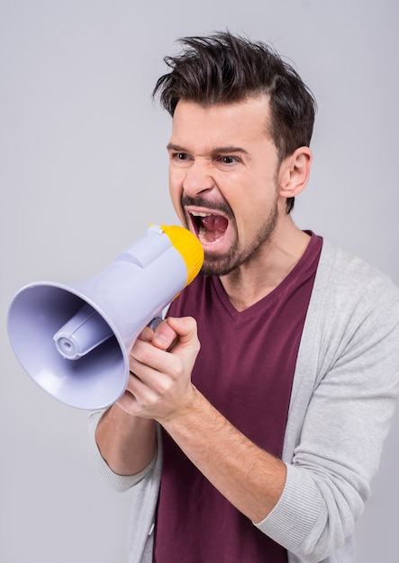 Young man is making announcement over a megaphone.