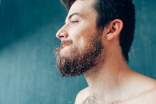 Young man isolated over blue background