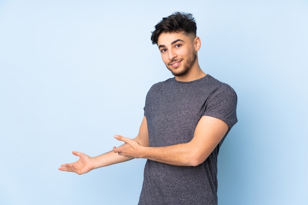 Young man isolated on blue