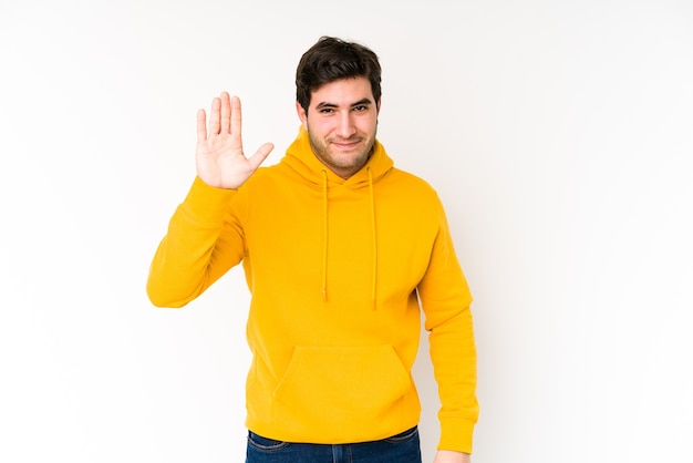 Young man isolated on white smiling cheerful showing number five with fingers.