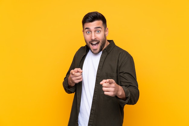 Young man over isolated yellow wall