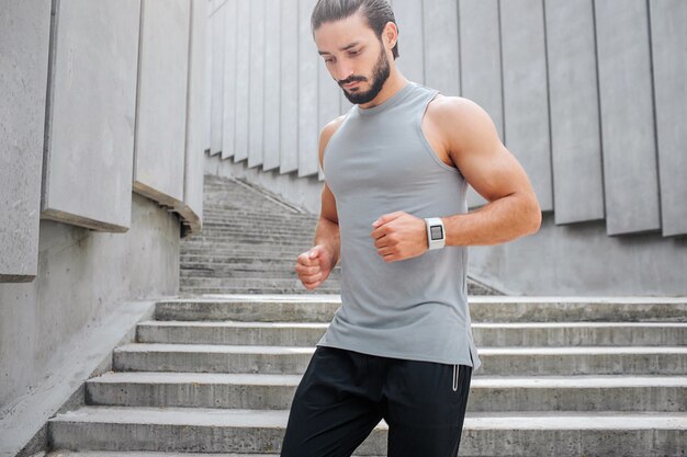 Young man jogging at the stairs