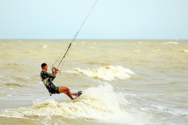 Young Man KiteBoarding on the waves Extreme Sport Kitesurfing