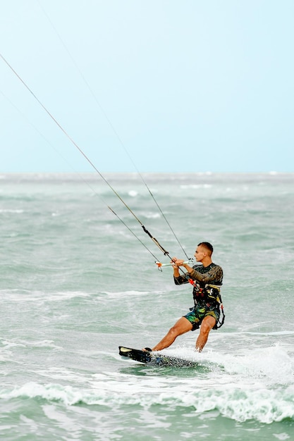 Young Man KiteBoarding on the waves Extreme Sport Kitesurfing