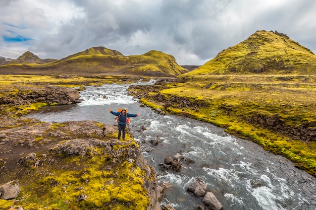 A young man on a large river from the 54 km trek from Landmannalaugar, Iceland