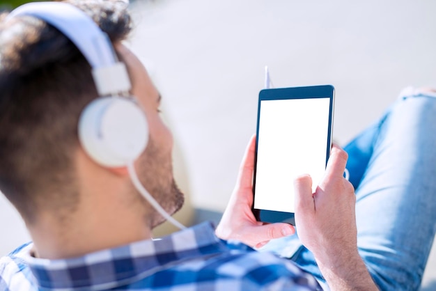 Young man listening to music on a smart phone