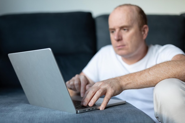 Young man listens to music and works at the computer