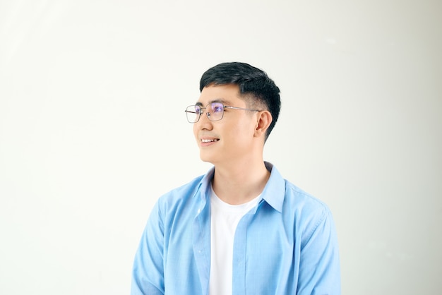 Young man looking away standing, wearing round glasses, isolated on white