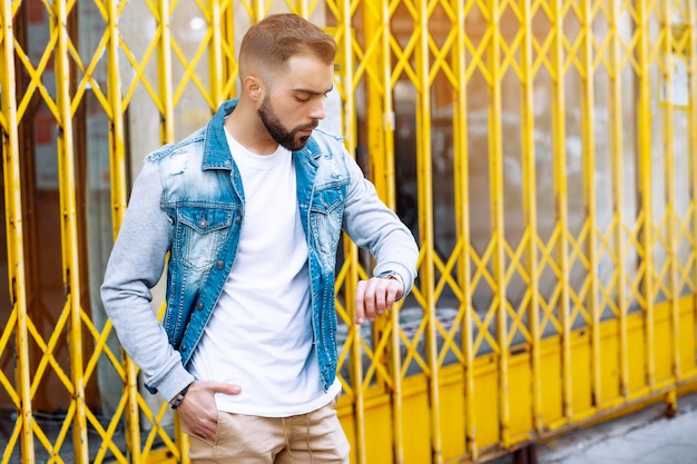 Young man looking at time on wristwatch