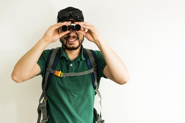 Young man looks through the binoculars