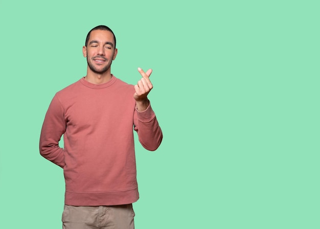 Young man making a gesture of worried about his economy