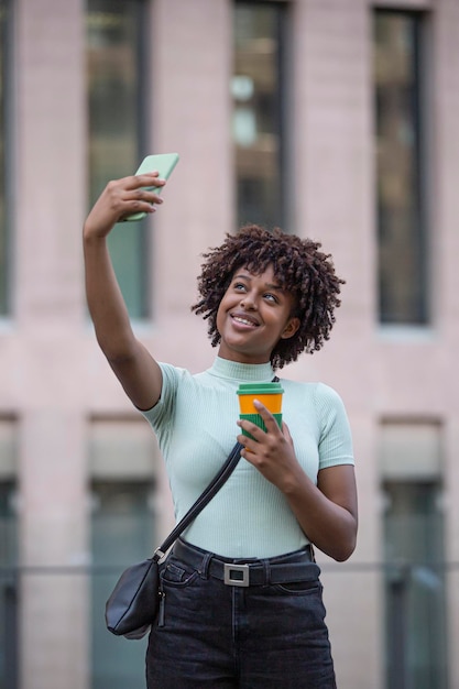 Young man making selfie with mobile phone Young woman outdoors in the city Technology and lifestyle concept