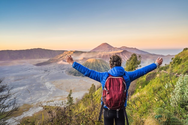 Young man meets the sunrise at the bromo tengger semeru national park on the java island indonesia