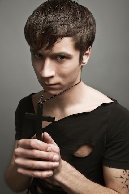 Young man in modern black clothing and freedom tattoo