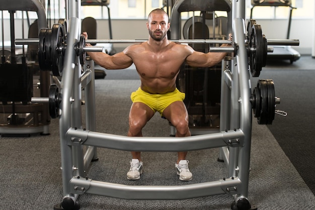 Young Man Performing Barbell Squats One Of The Best Bodybuilding Exercise For Legs