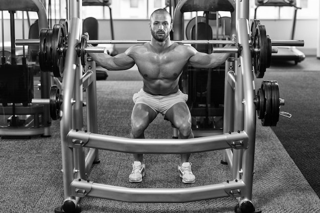 Young Man Performing Barbell Squats One Of The Best Bodybuilding Exercise For Legs