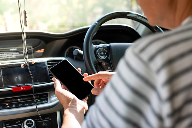 Young man play mobile while driving the car