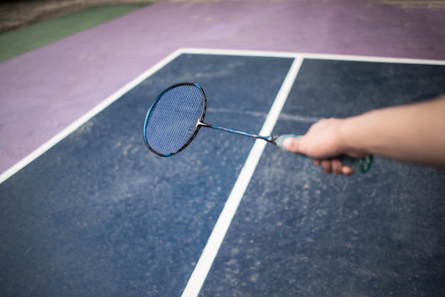 Young man playing badminton outdoors