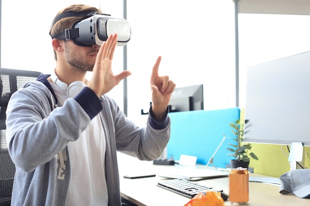 Young man playing game using virtual reality headset in the playing club.