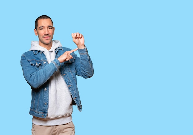 Young man pointing to his wrist