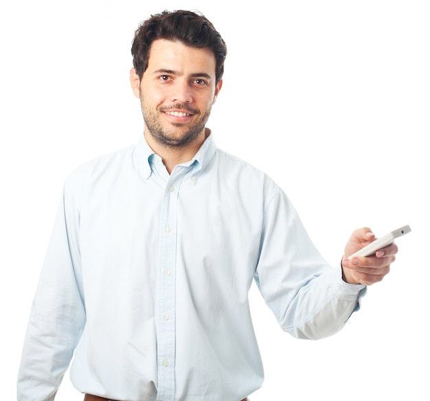 Young man pointing with a remote control on a white background