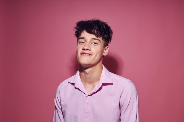 A young man posing fashion pink shirt modern style pink background unaltered