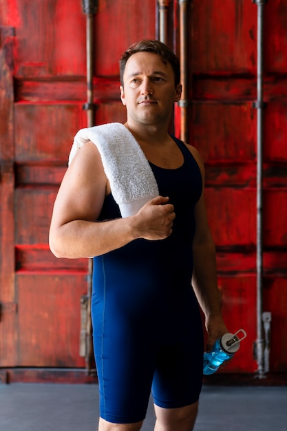 Young man posing in wrestling gear and clothing