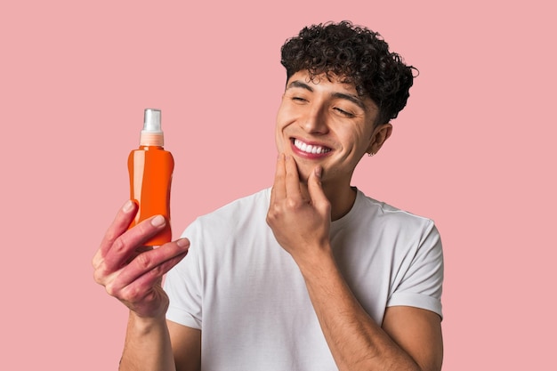 A young man protects his skin from harmful UV rays applying nongreasy broadspectrum sunscreen