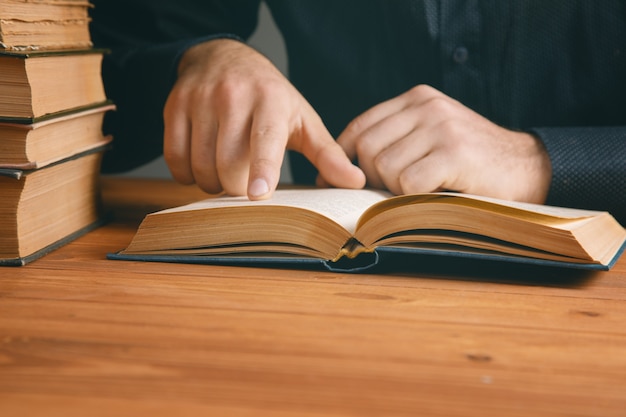 Young man reading a book .