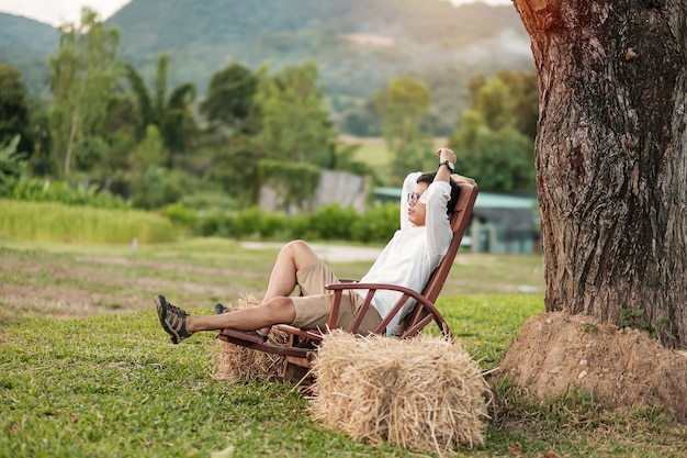 Photo young man relaxing in garden. nature and freedom concept