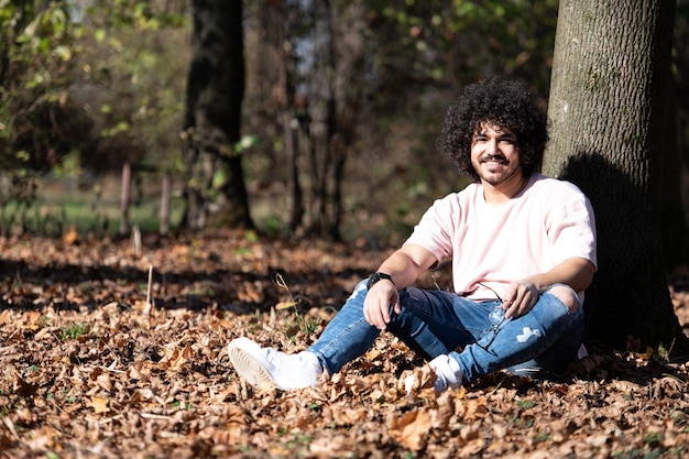 Young Man Resting in Autumn Forest