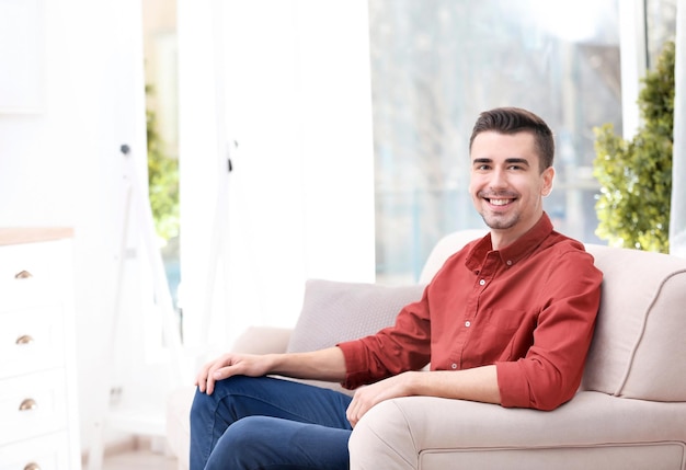 Young man resting on sofa at home