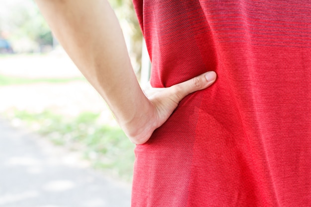 Young man runner suffering from Backache or Sore waist after running