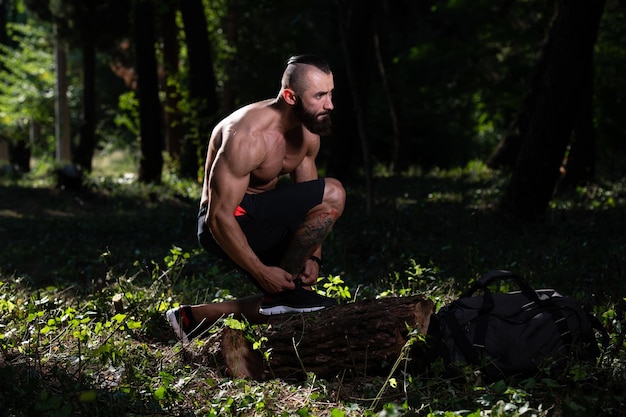 Young Man Runner Tying Shoelaces